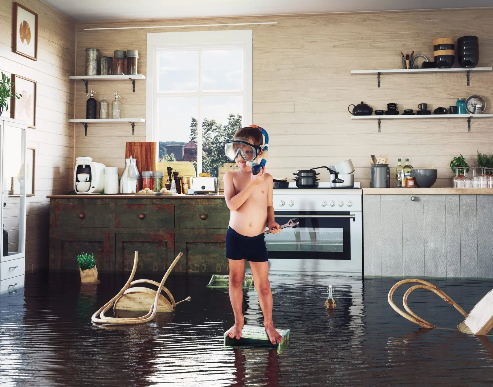 Active water leak flooding a residential kitchen